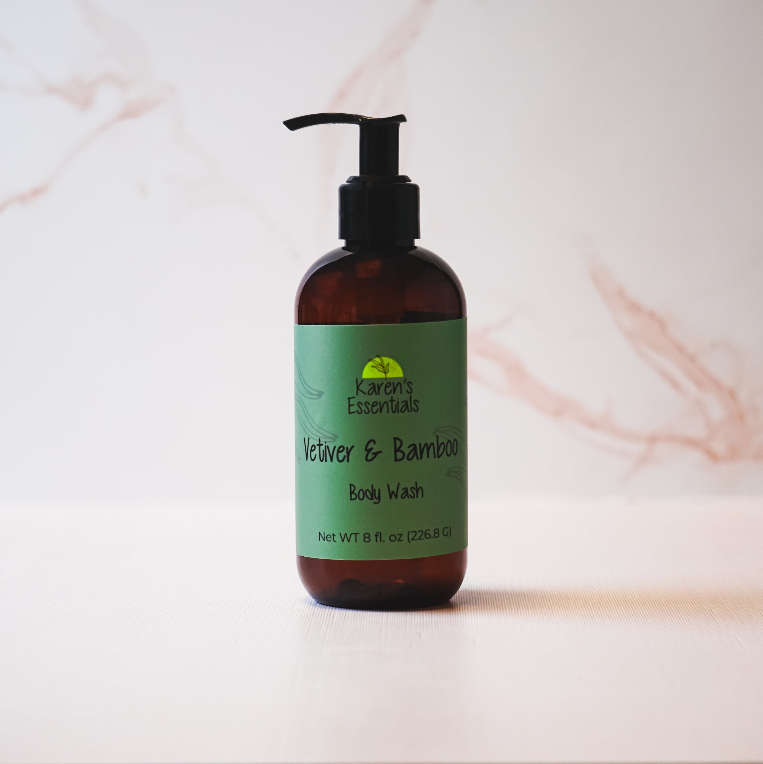 a black bottle with a dark brown tint with a green label on it, black text of the company name Karen Essentials, Vetiver & Bamboo Body Wash, Net WT 8 fl. oz